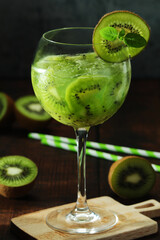 A glass with kiwi cocktail	