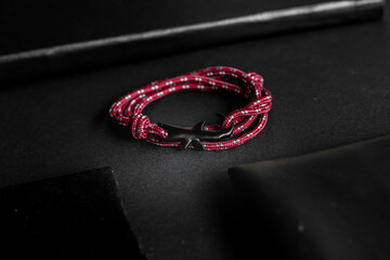 Fototapeta premium Red shark navigate bracelet on black background