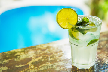 Tropical mixology on wooden bar, mixology with pool in a holiday setting. Caribbean cocktails.