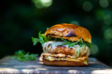 Pork and chorizo burger with cheese in brioche bun - obrazy, fototapety, plakaty