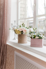 beautiful flowers in vases on old wooden windowsill