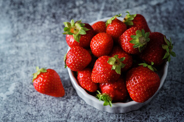Raw fresh strawberries on a light background