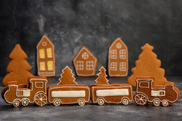 Christmas sweets toys. Gingerbread cookie in the form of a christmas train on dark table