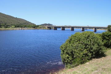 Fototapeta na wymiar Estuary in Plettenberg Bay, a highway bridge in the background. Next to the coast and Indian Ocean. Garden Route, South Africa, Africa.