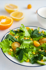 Light salad and z yellow tomato and corn with avocado and herbs. Orange and lemon soys with olive oil.