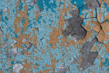 Peeling paint on the wall. Old concrete wall with cracked flaking paint. Weathered rough painted surface with patterns of cracks and peeling. High resolution texture for background and design. Closeup