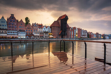 Old town in Gdansk with historical port crane over Motlawa river at sunset, Poland. © Patryk Kosmider