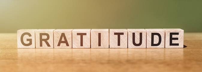 GRATITUDE word written on wood block. gratitude text on wooden table for your desing, concept.