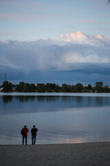 Silhouette of a man on a sunset background in the sity
