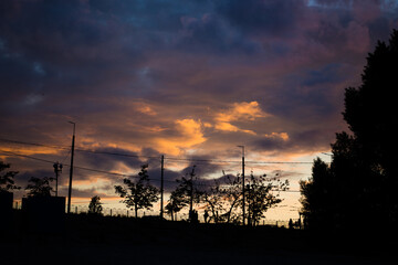 Silhouette of a man on a sunset background in the sity