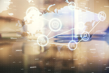 Double exposure of social network theme drawing hologram over coffee cup background in office....