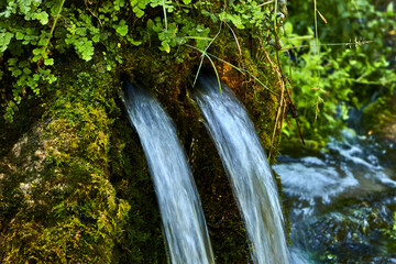 Fountain in a rock with two water pipes