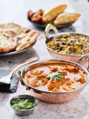 indian chicken tikka masala curry and saag paneer curries on table top