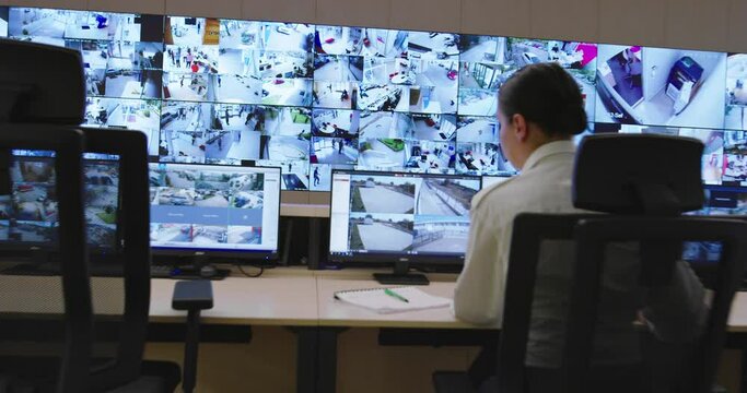 Security control room operator at work, Security System Operator Looking At Cctv Footage