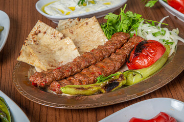 Turkish Adana Kebab Dinner on wooden background.