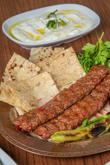 Turkish Adana Kebab Dinner on wooden background.
