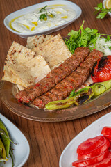 Turkish Adana Kebab Dinner on wooden background.