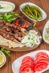 Turkish liver skewers on wooden background.