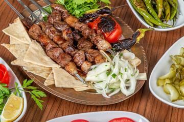 Turkish liver skewers on wooden background.