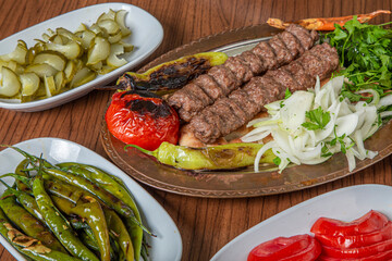 Turkish Urfa Kebab Skewer Dinner on Wooden Background
