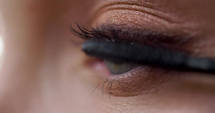 Close up Video Shot of Female Models working at studio while Makeup Artists Applying Mascara. Professional Cosmetic using for Magazine Shot. Beautiful woman with nice Eyes.
