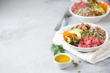 Healthy raw tuna bowl with quinoa and vegetales. Buddha bowl