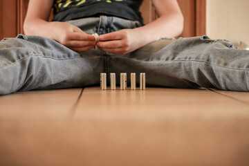 Child sitting on floor playing dominoes