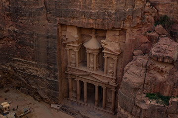 Fototapeta na wymiar Petra ancient treasure sand stone architecture exterior facade building carved in rock Middle East Jordan Arabian country foreshortening from above terrace view pint top
