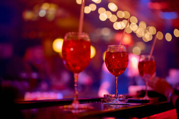 three red cocktails on the bar in the cafe