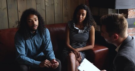 African american man husband talking to family counselor share problem with wife in unhappy couple marriage relationship sit on couch visiting male psychologist at counseling therapy session concept - Powered by Adobe