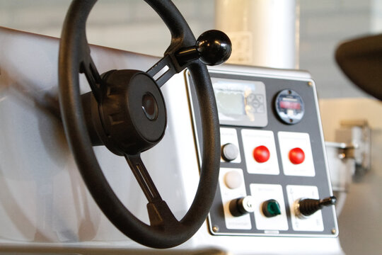 Closeup of a steering wheel and a dashboard of an ice maintenance vehicle.