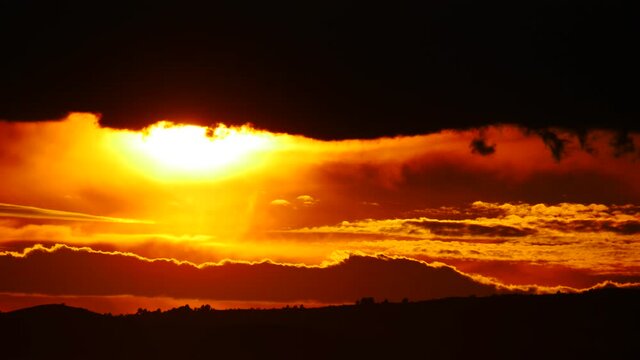 Skyscape. Burning sky, dark stormy clouds. Red orange color sunset over sea. Nature, coastal landscape. Capi Corb, Mediterranean coast of Spain