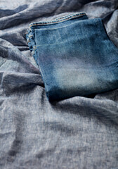 Fototapeta premium Jeans trousers on blue background. Copy space. 