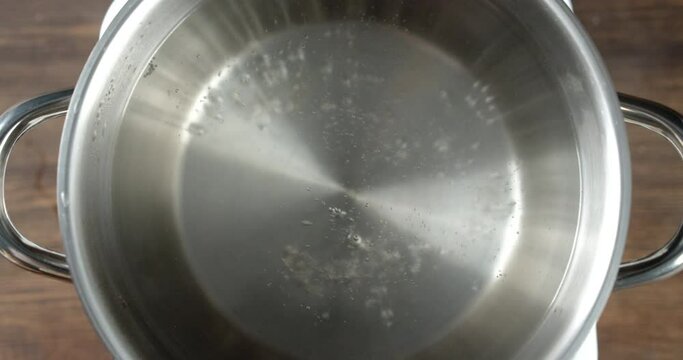 In a saucepan boil water with air bubbles and hot steam.