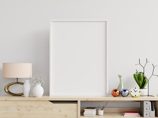 Poster mockup with vertical frame on table and white wall background.