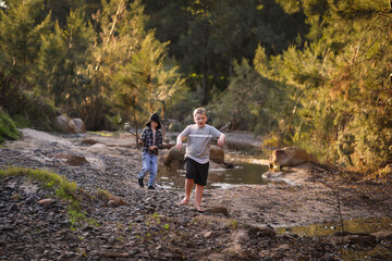 Two young boys walking in the bush
