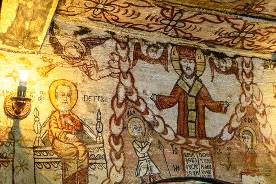 DESESTI, ROMANIA - JUNE 2, 2017: Frescoes inside the wooden Saint Parascheva Church, a Romanian Orthodox church in Desesti Commune, Maramures County, Romania.