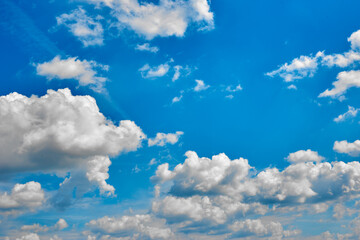 Naklejka na ściany i meble Beautiful blue sky with white clouds on a bright Sunny summer day