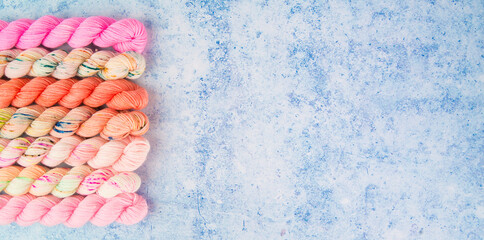Pink yarns on a vibrant blue background
