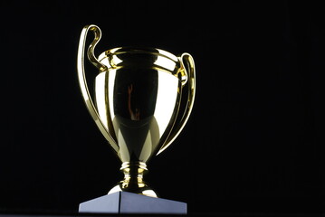 Golden trophy against black background
