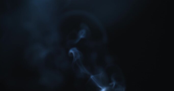 Real smoke on a black background. Thin Flexible Trickle of Real Smoke. Colorful real smoke rises up. Ideal for background or over-layer with blending mode add, screen, lighten