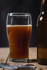 glass of stout beer on wooden table