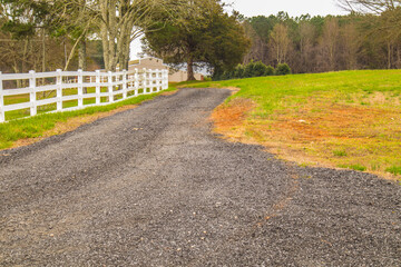 Stone Mountain, Ga / USA - 03 13 20: A gravel road along side a white fence