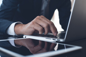 Businessman working on laptop computer in modern office