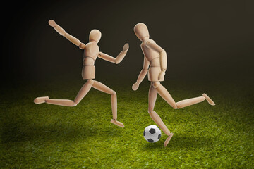 Wooden dummies models playing soccer