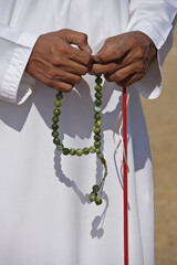 Muslim man in traditional dress with prayer beads, Al-Ain, Abu Dhabi, United Arab Emirates