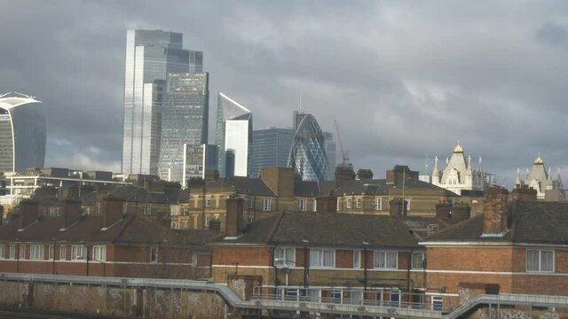A view of a financial London district from the window of a moving train.