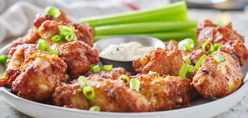 bbq garlic fried chicken wings with ranch dressing and celery sticks