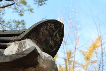 Traditional Korean ceramic roof tile with dragon image in sunny day at Gyeongju Yangdong Folk Village, South Korea