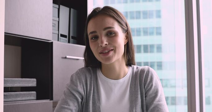 Beautiful young business woman hr manager talking during online job interview consulting client make conference video call look at camera having business conversation by videoconference, webcam view
